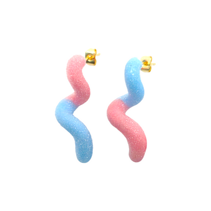 Pair of pink and blue wavy earrings on a white background